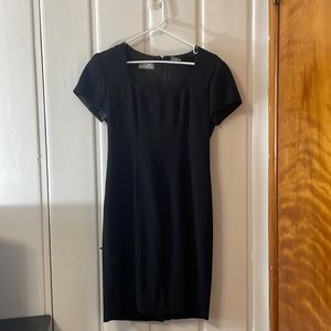 Short black form fitting mini dress with shoulderpads (can be removed)
